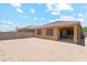 Backyard featuring desert landscaping, block fence, and a covered patio at 18333 N Presley Ln, Maricopa, AZ 85138