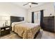 This cozy bedroom boasts neutral walls and carpet with window coverings, ceiling fan, and furniture at 18333 N Presley Ln, Maricopa, AZ 85138