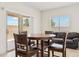 Dining room area with a table, four chairs and a sliding glass door to a patio at 18333 N Presley Ln, Maricopa, AZ 85138