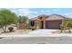 Attractive single-story home featuring a well-manicured yard and a two-car garage at 18333 N Presley Ln, Maricopa, AZ 85138
