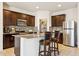 A kitchen with stainless steel appliances, granite countertops, and two stools at 18333 N Presley Ln, Maricopa, AZ 85138