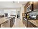 Modern kitchen with granite countertops, stainless steel appliances, and stylish backsplash at 18333 N Presley Ln, Maricopa, AZ 85138