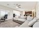 Open-concept living room with a large sectional couch flowing to the kitchen at 18333 N Presley Ln, Maricopa, AZ 85138