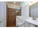 Bathroom featuring a tiled shower and pedestal sink at 18651 N Salerno Ct, Surprise, AZ 85387