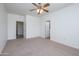 Bright bedroom featuring a ceiling fan and dual doorways to additional areas at 18651 N Salerno Ct, Surprise, AZ 85387