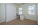Spare bedroom featuring a wall bed, built-in shelving, desk and window views at 18651 N Salerno Ct, Surprise, AZ 85387