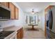 Sunny dining nook with a round table and surrounding windows and wood cabinets at 18651 N Salerno Ct, Surprise, AZ 85387