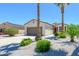 Well maintained home featuring desert landscaping, two-car garage and palm trees at 18651 N Salerno Ct, Surprise, AZ 85387