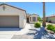 Well maintained home featuring two-car garage, desert landscaping, and covered porch at 18651 N Salerno Ct, Surprise, AZ 85387