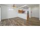 Open floor plan with wood-look floors connecting the living room and kitchen at 18651 N Salerno Ct, Surprise, AZ 85387