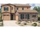 Inviting two-story home showcasing stone accents, a two-car garage, and a welcoming front entry at 1972 W Rowel Rd, Phoenix, AZ 85085