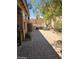 Cozy backyard featuring a brick patio, seating area, and mature trees providing shade at 2125 E Danbury Rd, Phoenix, AZ 85022