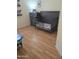 Bedroom featuring a wooden crib and dresser on laminate floors at 2125 E Danbury Rd, Phoenix, AZ 85022
