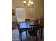 Dining area featuring a wooden table, chairs, and natural light from a large window at 2125 E Danbury Rd, Phoenix, AZ 85022
