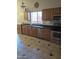 Updated kitchen featuring wood cabinets, stainless steel appliances, and tile floors at 2125 E Danbury Rd, Phoenix, AZ 85022