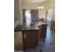 Kitchen island featuring a dark countertop, cabinets, and bar seating at 2125 E Danbury Rd, Phoenix, AZ 85022