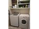 Functional laundry room with a modern washer and dryer, plus convenient overhead shelving at 2125 E Danbury Rd, Phoenix, AZ 85022