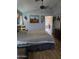 Bedroom with a ceiling fan, wood laminate floors, and an ensuite bathroom at 2125 E Danbury Rd, Phoenix, AZ 85022