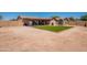 Large backyard featuring a covered patio, artificial turf, and a convenient storage shed at 215 S 132Nd St, Chandler, AZ 85225
