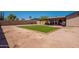 This backyard features lush artificial turf, a covered patio, and is ideal for outdoor entertaining at 215 S 132Nd St, Chandler, AZ 85225