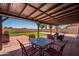 Relaxing covered patio and backyard featuring lush artificial turf, ideal for outdoor enjoyment at 215 S 132Nd St, Chandler, AZ 85225