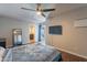 Bedroom with wood floors, ceiling fan, and patio access at 215 S 132Nd St, Chandler, AZ 85225