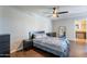 Bedroom with wood floors, ceiling fan, and access to the bathroom at 215 S 132Nd St, Chandler, AZ 85225