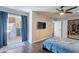 Bedroom with wood floors, closet, ceiling fan, and patio access at 215 S 132Nd St, Chandler, AZ 85225