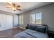Bedroom featuring hardwood floors, a ceiling fan and two bright windows at 215 S 132Nd St, Chandler, AZ 85225