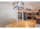 Dining area showcasing a hardwood table, modern light fixture and view into the kitchen at 215 S 132Nd St, Chandler, AZ 85225