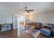 Spacious living room with hardwood floors, ceiling fan, and an open view into the dining room at 215 S 132Nd St, Chandler, AZ 85225