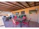Covered patio featuring an outdoor seating area with TV and grilling space, perfect for entertaining at 215 S 132Nd St, Chandler, AZ 85225