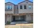 Two-story townhome with stucco, brick accents, an attached garage, and manicured landscaping at 2367 E Huntington Dr, Phoenix, AZ 85040
