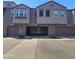 Modern townhome exterior with attached garages, detailed stucco, and a well-maintained driveway at 2367 E Huntington Dr, Phoenix, AZ 85040
