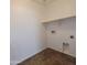 A simple laundry room with a clean white wall, with hookups for washer and dryer at 2367 E Huntington Dr, Phoenix, AZ 85040