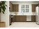Functional kitchen featuring stainless steel appliances, wood cabinetry, and a well-lit workspace at 24647 N 164Th Dr, Surprise, AZ 85387