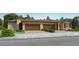 Charming single-story home featuring a tile roof, well-manicured lawn, and a two-car garage, creating an inviting curb appeal at 24962 N 174Th Ave, Surprise, AZ 85387