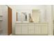 Modern bathroom with a double vanity, large mirror, and a walk-in shower at 25004 N 174Th Ave, Surprise, AZ 85387