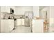 Bright, white kitchen featuring stainless steel appliances, ample cabinet space, and a functional center island at 25004 N 174Th Ave, Surprise, AZ 85387