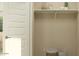 Versatile storage area with a white door, open shelf, baskets, neutral walls, and potential for customization at 25004 N 174Th Ave, Surprise, AZ 85387
