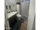 Cozy bathroom featuring a vanity with dark cabinets and a tub with a floral shower curtain at 300 S Val Vista Dr # 54, Mesa, AZ 85204