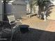 A peaceful backyard setting with chairs, firepit, and sheds offering a relaxing outdoor area at 300 S Val Vista Dr # 54, Mesa, AZ 85204