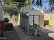 A cozy backyard featuring a shed, air conditioning unit, and an enclosed patio area with comfortable seating at 300 S Val Vista Dr # 54, Mesa, AZ 85204