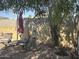 A quaint backyard space with gravel, block wall, trees, and comfortable patio furniture for outdoor relaxation at 300 S Val Vista Dr # 54, Mesa, AZ 85204