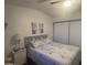 Inviting bedroom featuring a cozy bed, a bedside table, and sliding door wardrobe at 300 S Val Vista Dr # 54, Mesa, AZ 85204