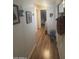 Clean hallway features wood-style flooring and access to multiple rooms at 300 S Val Vista Dr # 54, Mesa, AZ 85204