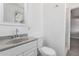 Clean bathroom featuring a white vanity, toilet, and tile flooring with updated fixtures at 3126 W Stella Ln, Phoenix, AZ 85017