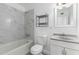 Modern bathroom featuring a tiled shower/tub, updated fixtures, and a white vanity at 3126 W Stella Ln, Phoenix, AZ 85017
