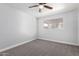 Bright bedroom with carpet, ceiling fan, and window offers a serene, comfortable retreat at 3126 W Stella Ln, Phoenix, AZ 85017