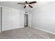 Neutral bedroom with carpet, ceiling fan, and closet offers a serene, comfortable retreat at 3126 W Stella Ln, Phoenix, AZ 85017